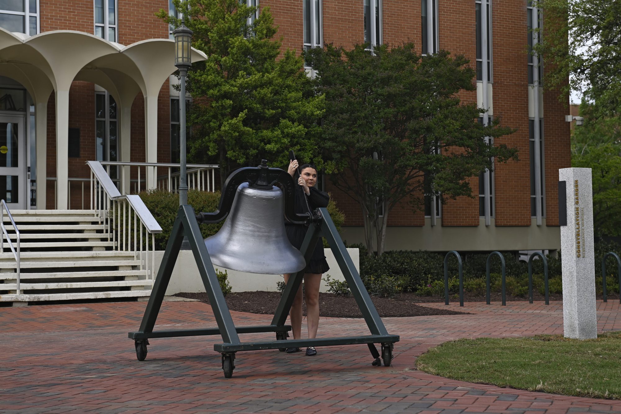 Tatiyana Larson rings the bell during the April 30 Memorial ceremony.