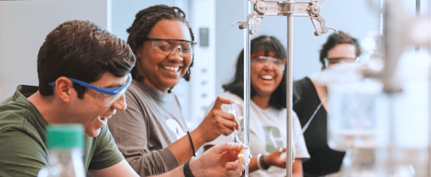 A group of students in a science lab doing experiments. 