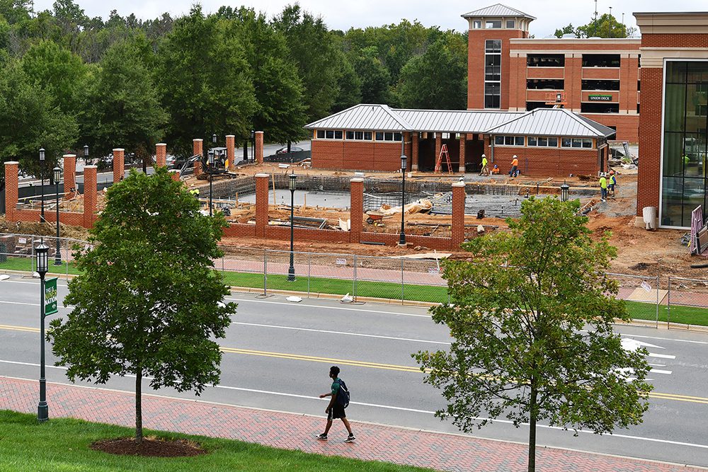 UNC Charlotte student walks by URC construction