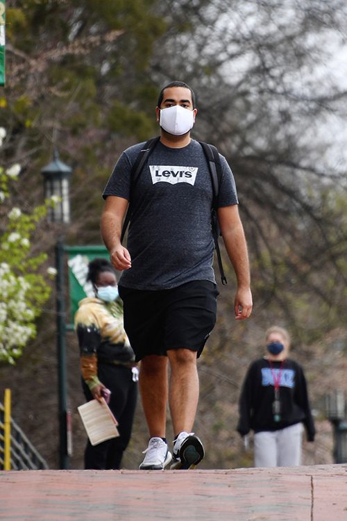 student walking on UNC Charlotte campus