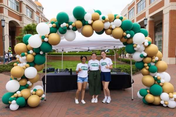 Three Niners under a balloon arch